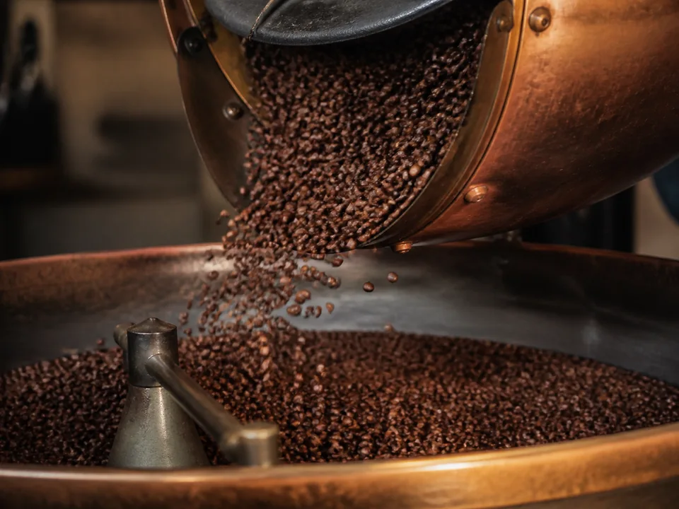 Roasted beans moving through a copper roasting detail.